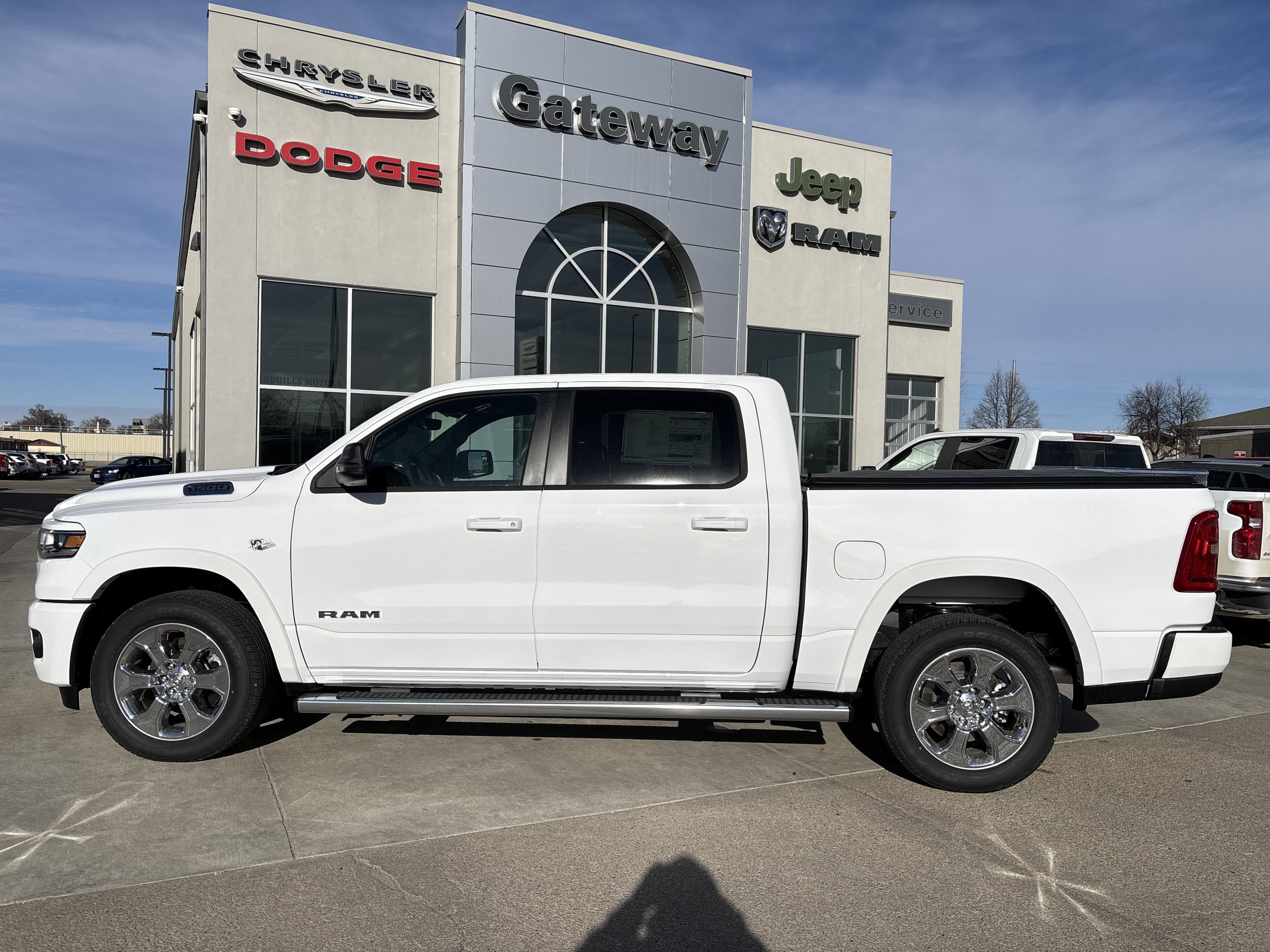 2026 RAM Ram 1500 RAM 1500 BIG HORN CREW CAB 4X4 5'7' BOX in Bright White Clear-Coat Exterior Paint — front three-quarter view