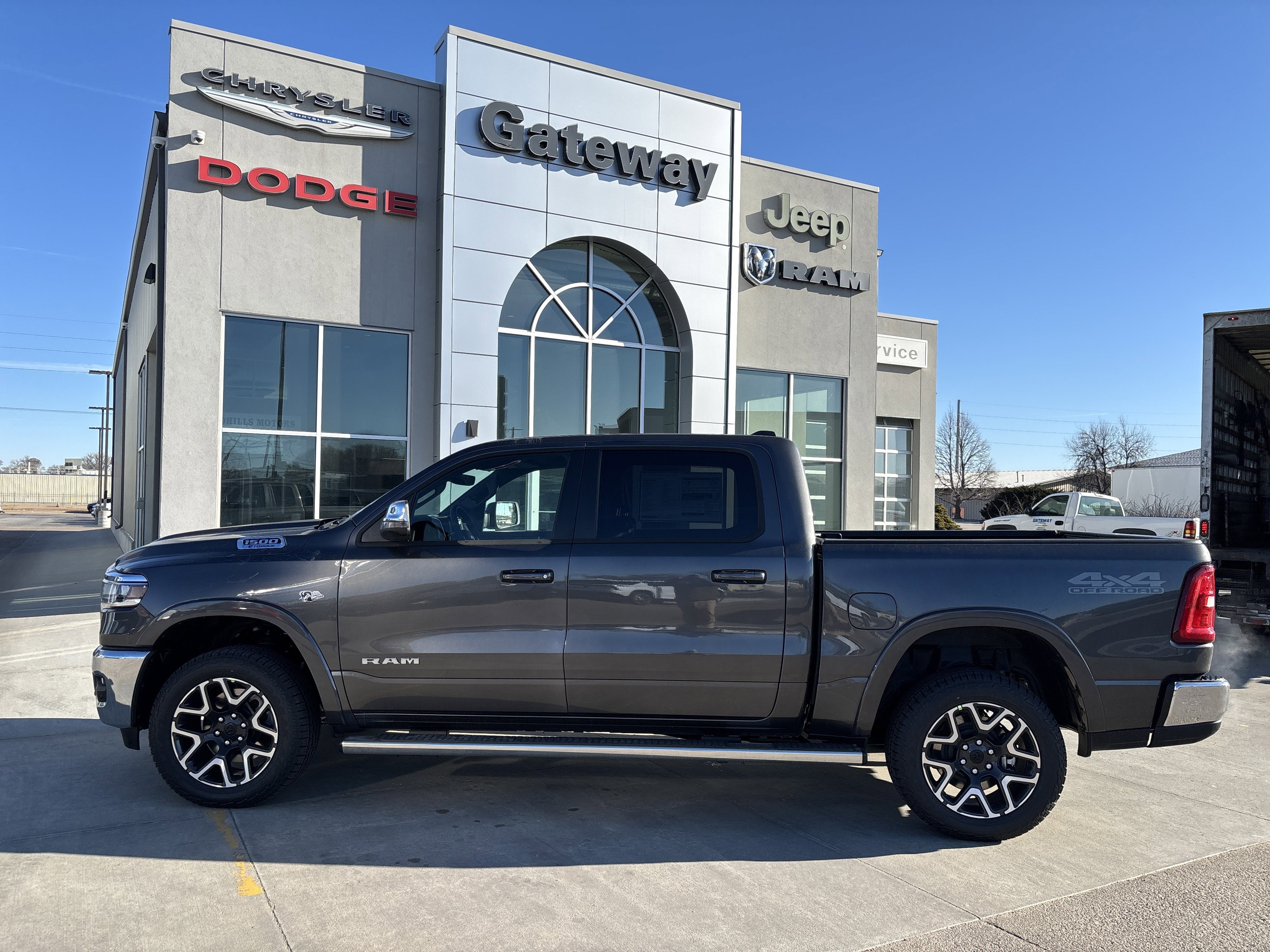 2026 RAM Ram 1500 RAM 1500 LARAMIE CREW CAB 4X4 5'7' BOX in Granite Crystal Metallic Clear-Coat Exterior Paint — front three-quarter view