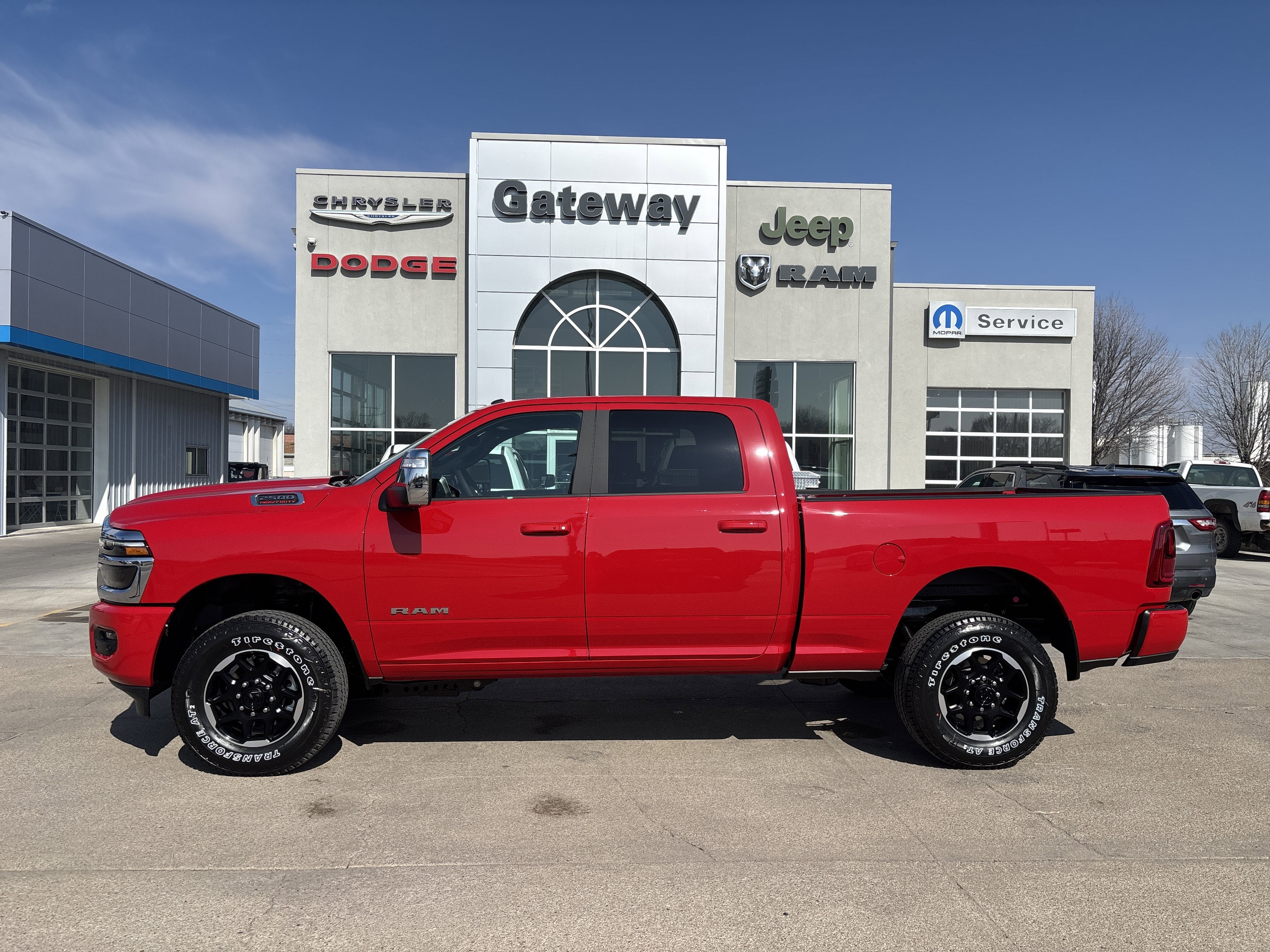 2026 RAM Ram 2500 RAM 2500 LARAMIE CREW CAB 4X4 6'4' BOX in Flame Red Clear-Coat Exterior Paint — front three-quarter view